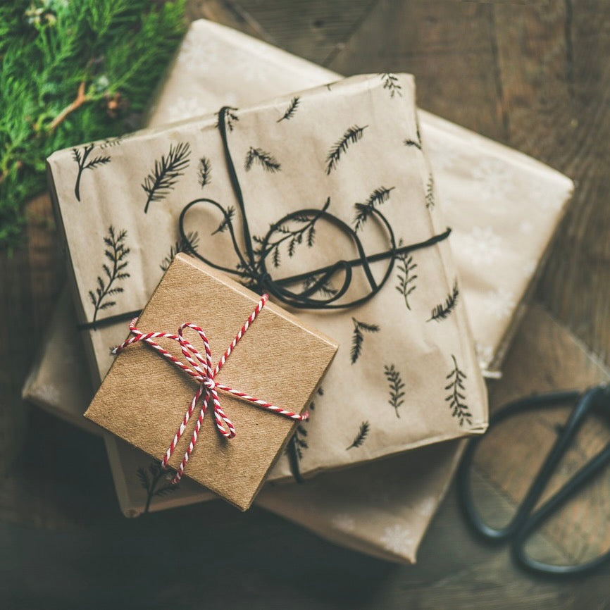 Three holiday packaged in gift wrapping