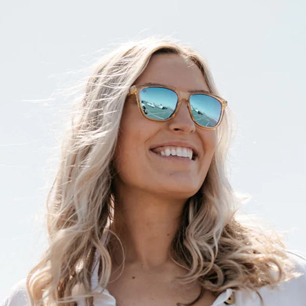 Woman wearing Knockaround Beach Peach Classics Sunglasses