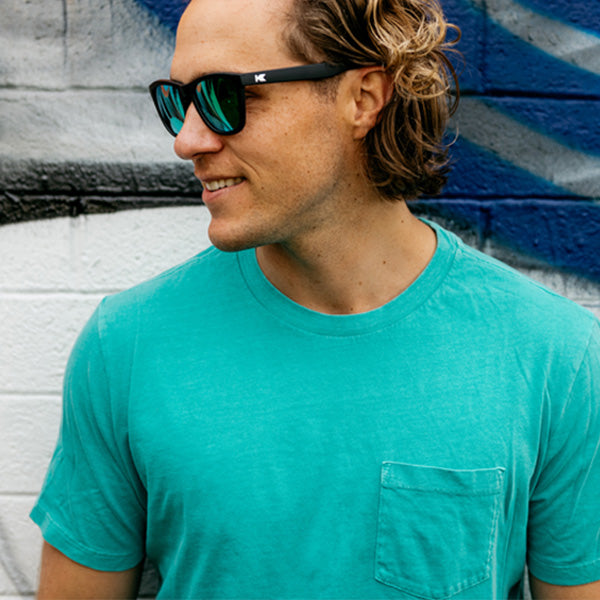 Man wearing Knockaround Black Green Moonshine Premiums Sunglasses