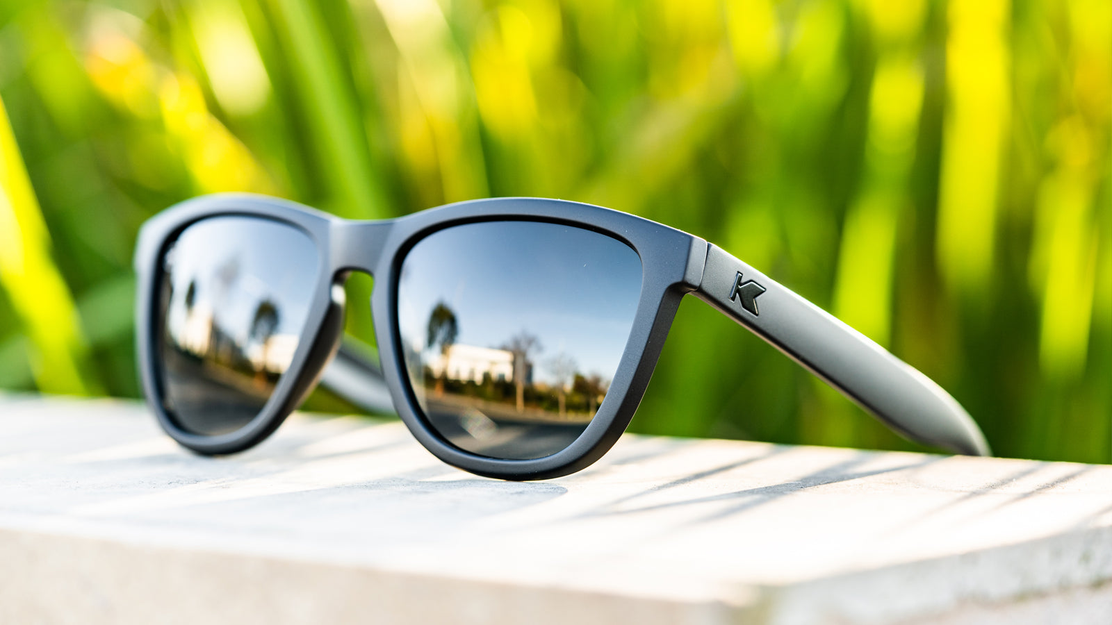 Lifestyle photo of Black on Black Premiums Sunglasses