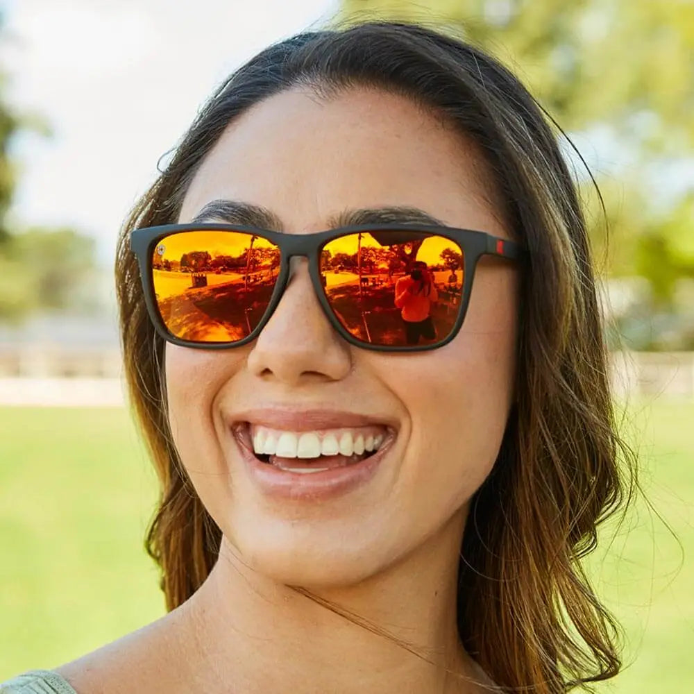 Women wearing Matte Black / Red Sunset Fast Lanes Sunglasses