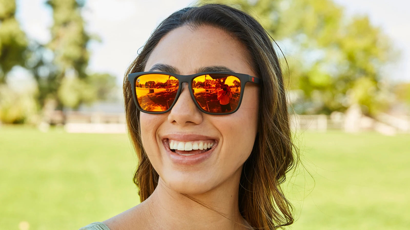Women wearing Matte Black / Red Sunset Fast Lanes Sunglasses