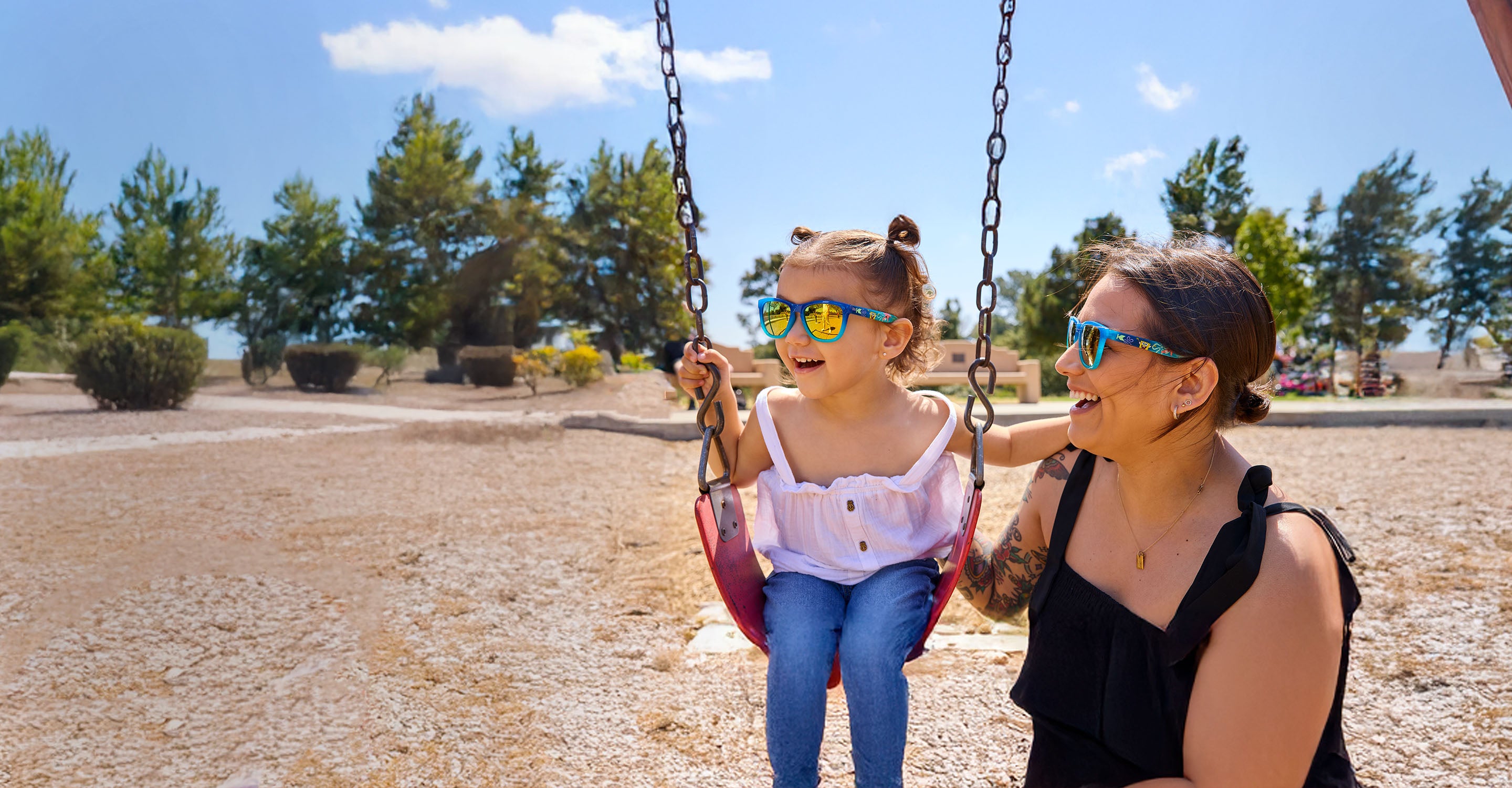Mother and daughter in a park wearing matching SpongeBob SquarePants sunglasses by Knockaround