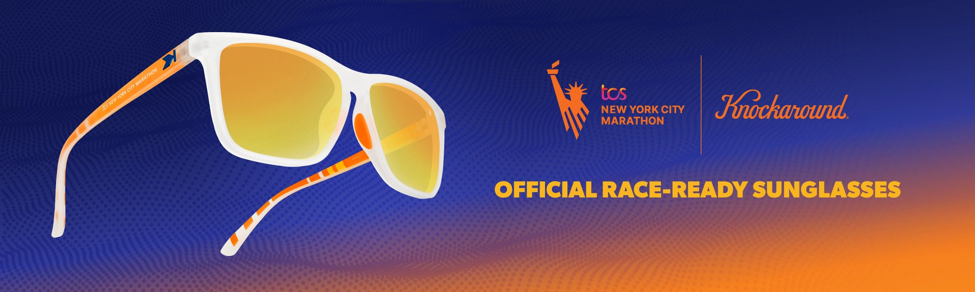 Sunglasses with orange and white frame on a blue and orange gradient background, featuring Knockaround and TCS New York City Marathon logos. Official race-ready sunglasses