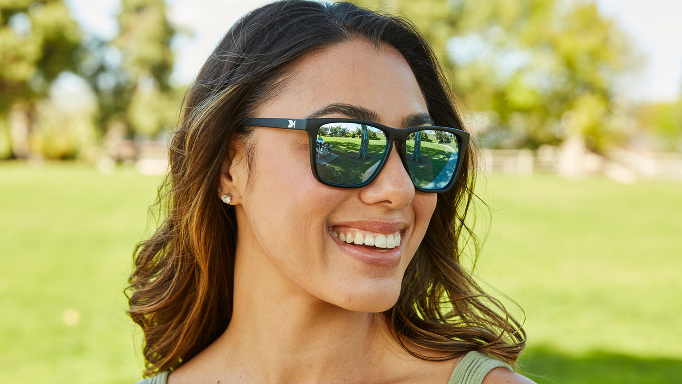 Woman wearing Matte Black / Sky Blue fast lanes sunglasses