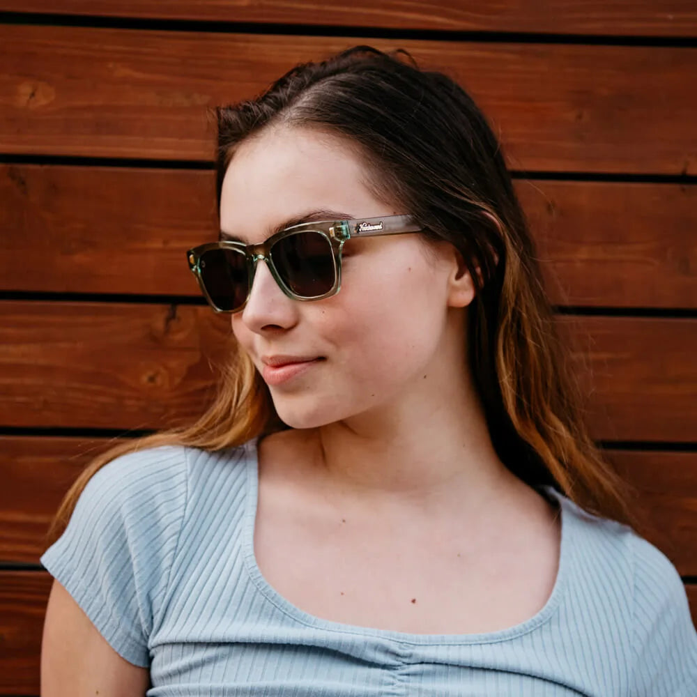Woman wearing Aged Sage / Amber Seventy Nines sunglasses