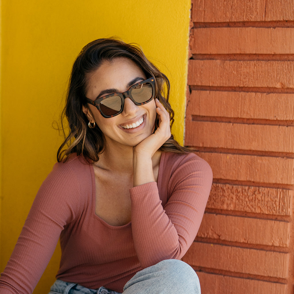 Woman wearing Knockaround Songbirds tortoise shell sunglasses