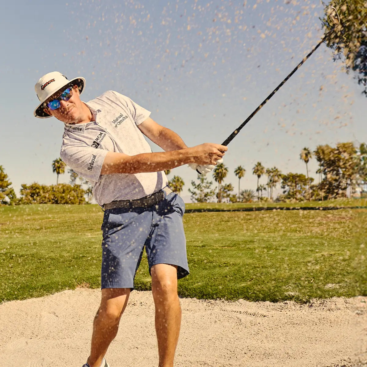 Joel Damhen playing Golf and wearing Knockaround sunglasses