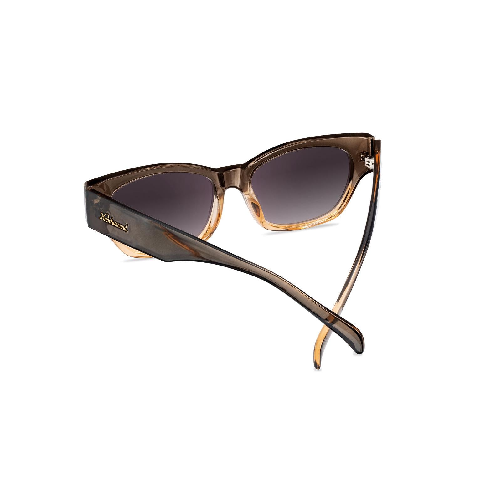 Sunglasses with a glossy muted-gray-to-peach frame and polarized smoke gradient lenses, Back