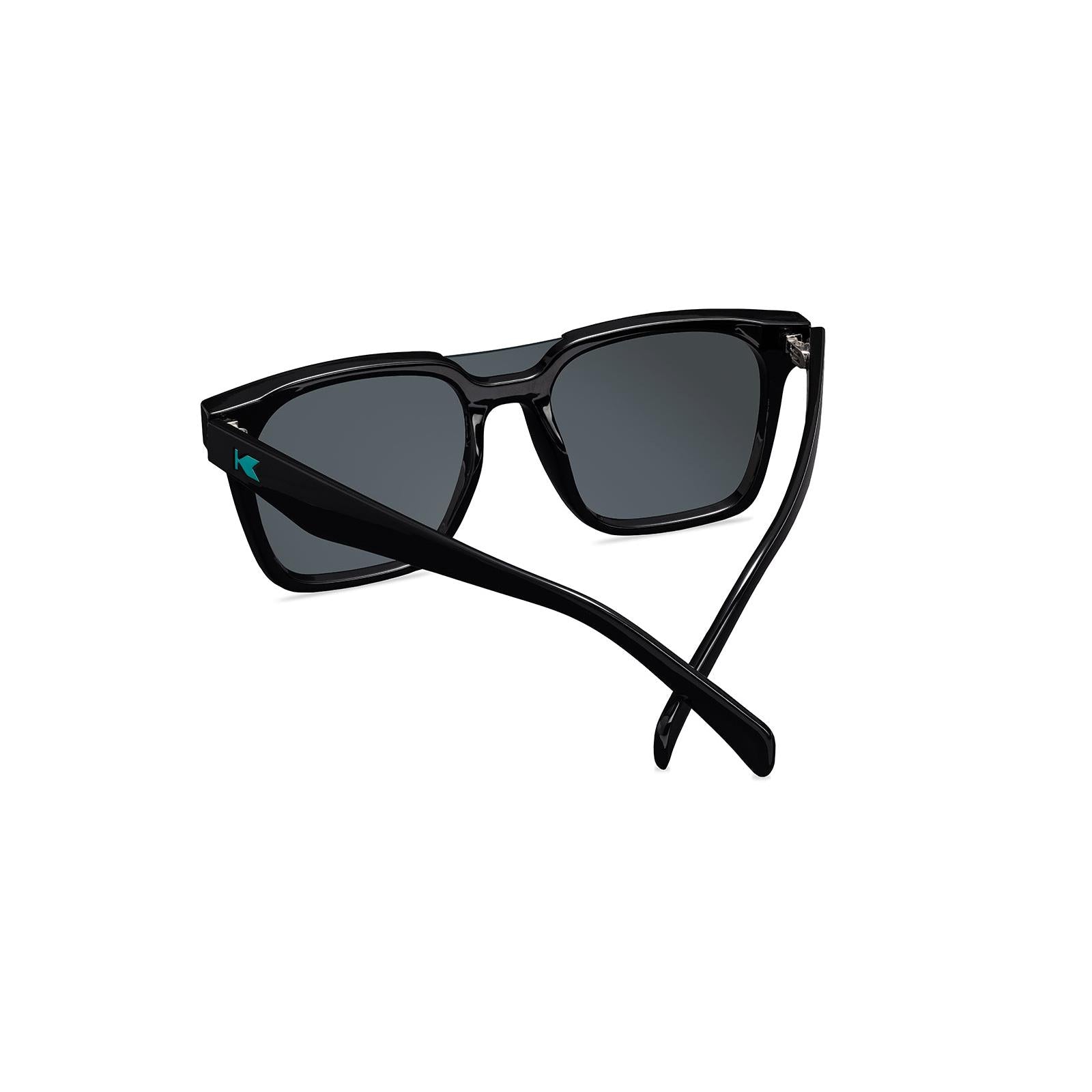 Sunglasses with a black frame with polarized green lenses, back