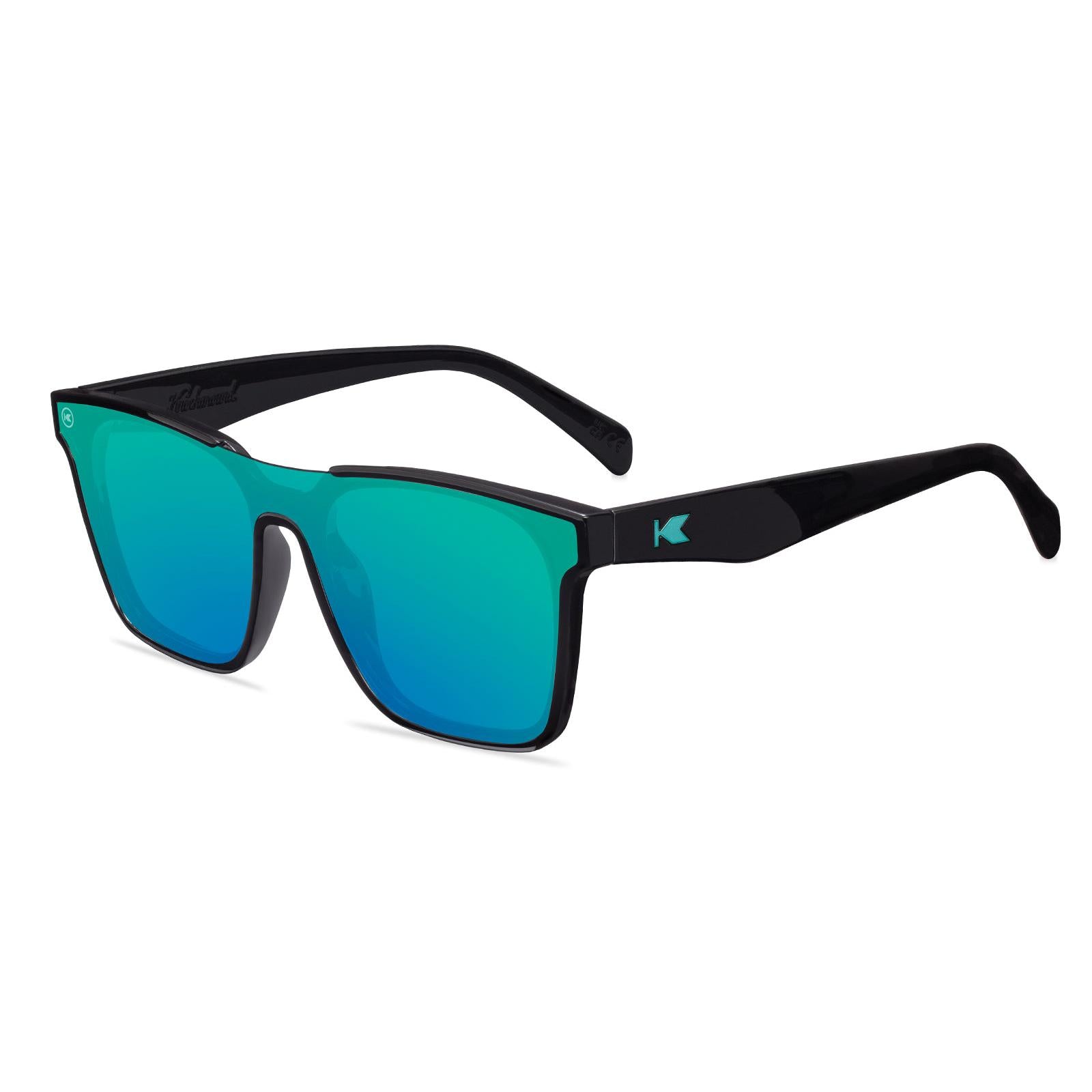 Sunglasses with a black frame with polarized green lenses, flyover