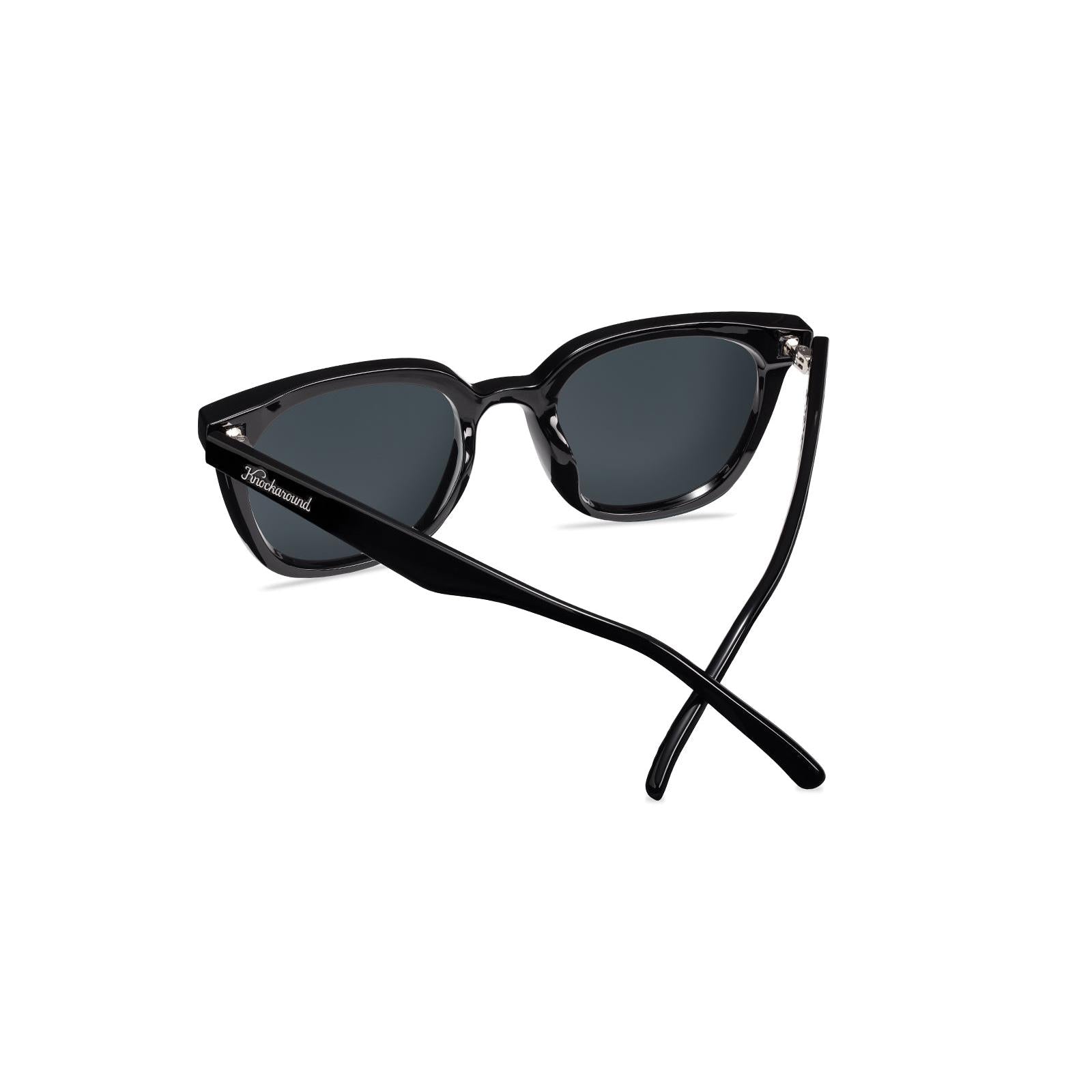 Sunglasses with a black frame with polarized blue lenses, back