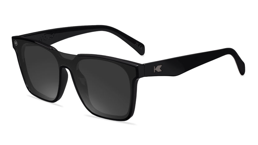 Sunglasses with a black frame with polarized black lenses, flyover