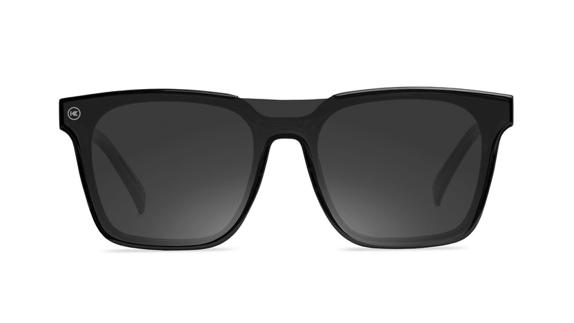 Sunglasses with a black frame with polarized black lenses, front