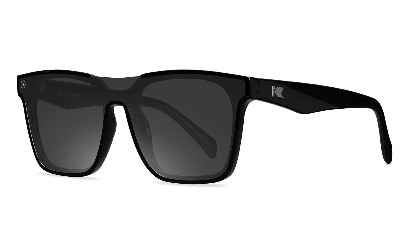 Sunglasses with a black frame with polarized black lenses, threequarter