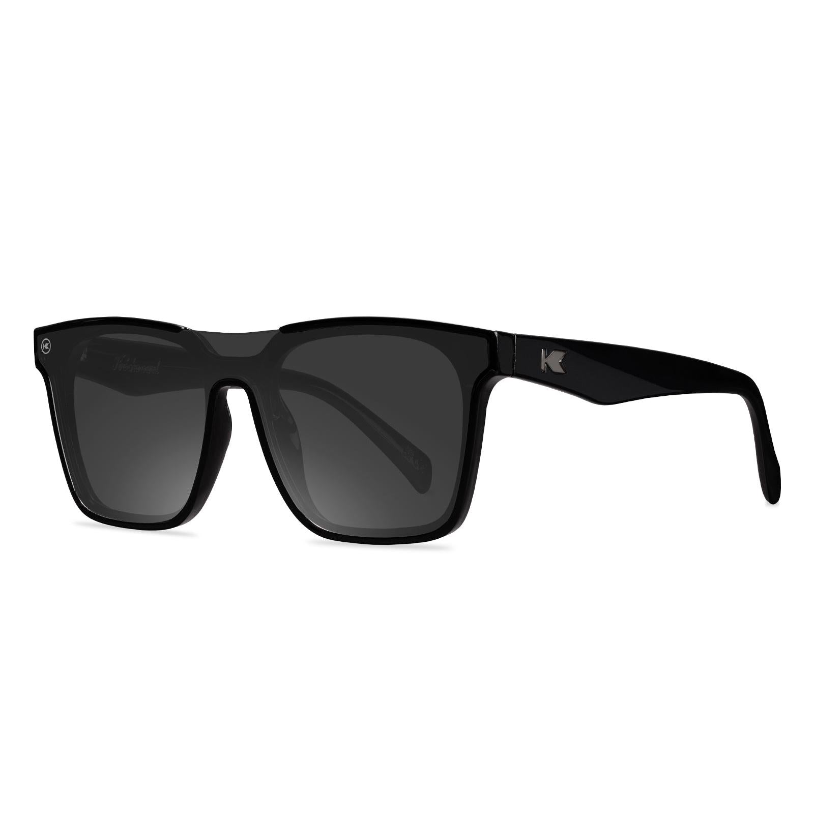 Sunglasses with a black frame with polarized black lenses, threequarter