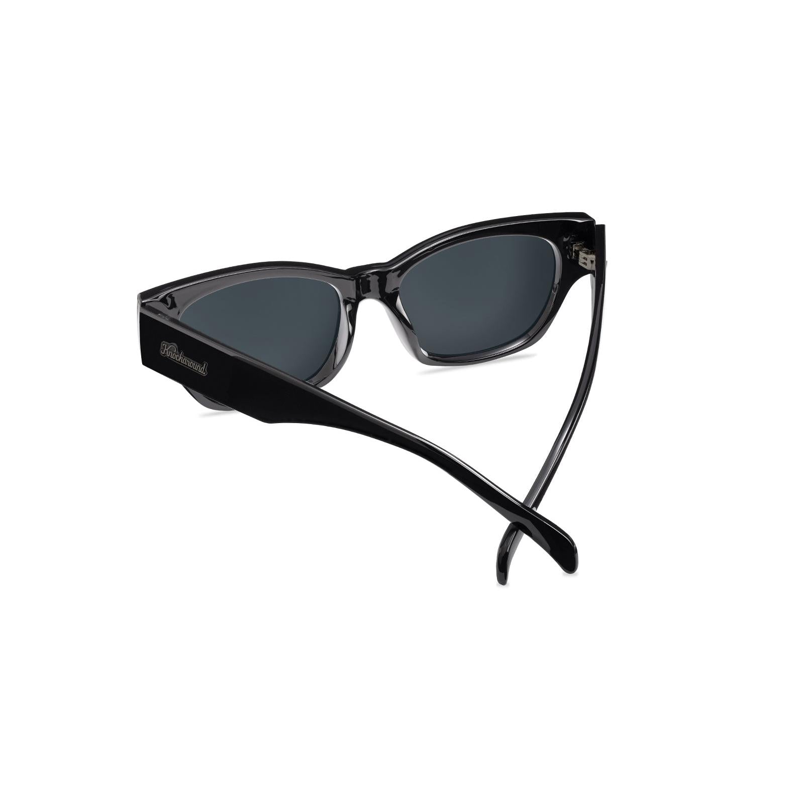 Sunglasses with a glossy black frame and polarized smoke lenses, Back