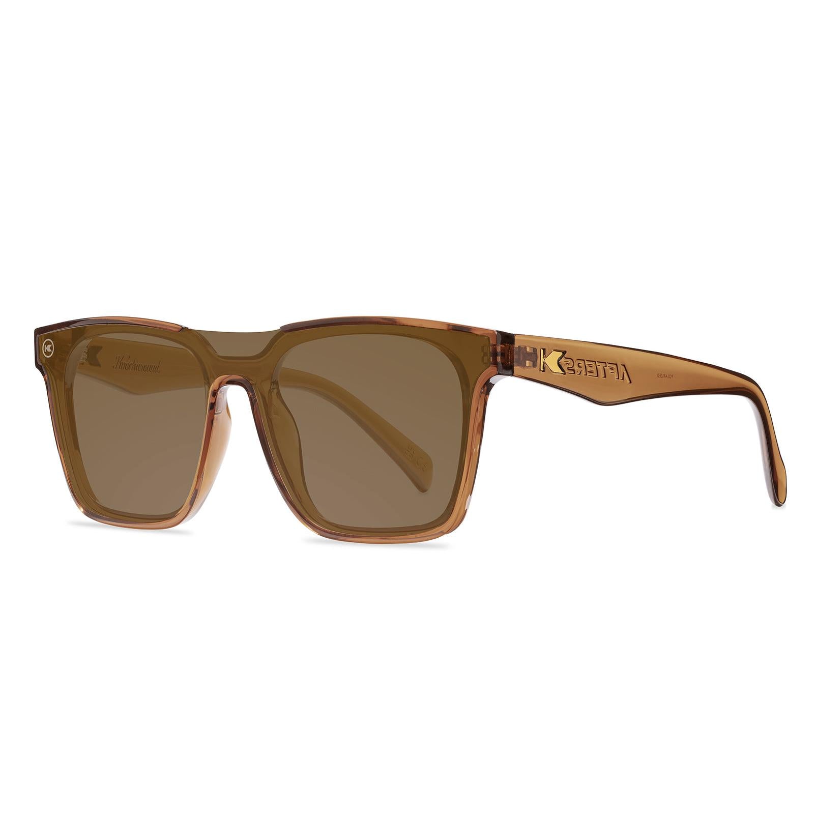 Sunglasses with an amber frame with polarized amber lenses, threequarter