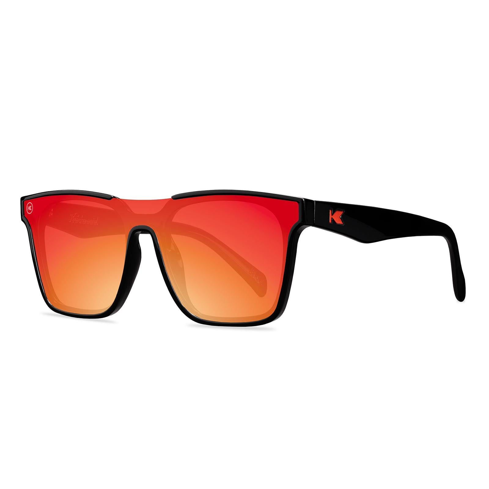 Sunglasses with a black frame with polarized orange lenses, threequarter