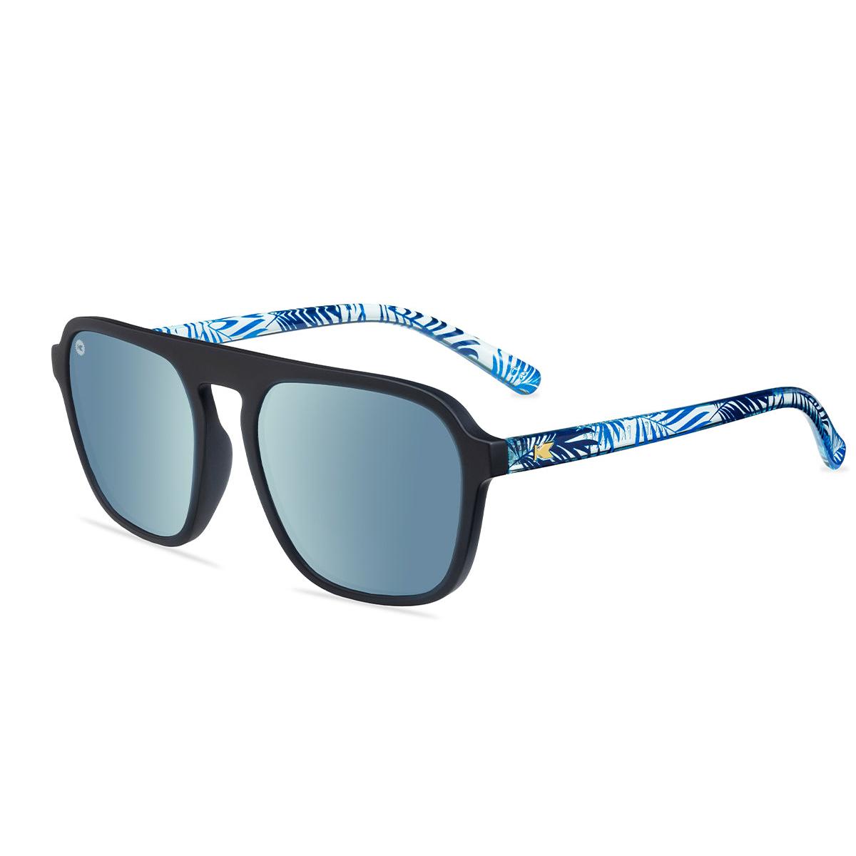 Sunglasses with black fronts, blue palm tree arms and polarized sky blue lenses, flyover