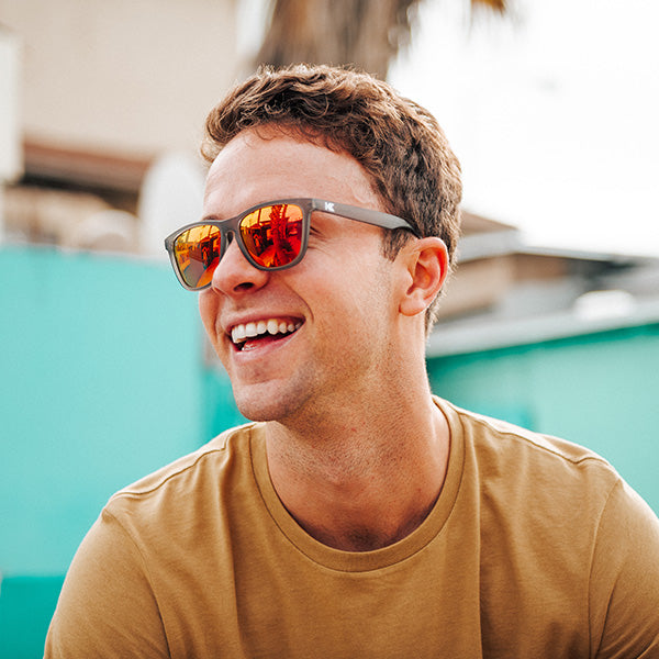 Man wearing Sunglasses with Frosted Grey Frame and Polarized Red Sunset Lenses