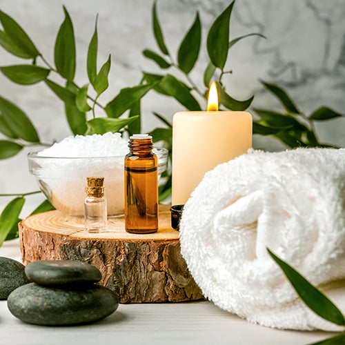 Beauty treatment items for spa procedures on white wooden table