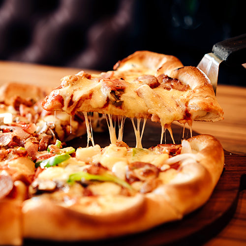 Slice of pizza with various pizza toppings