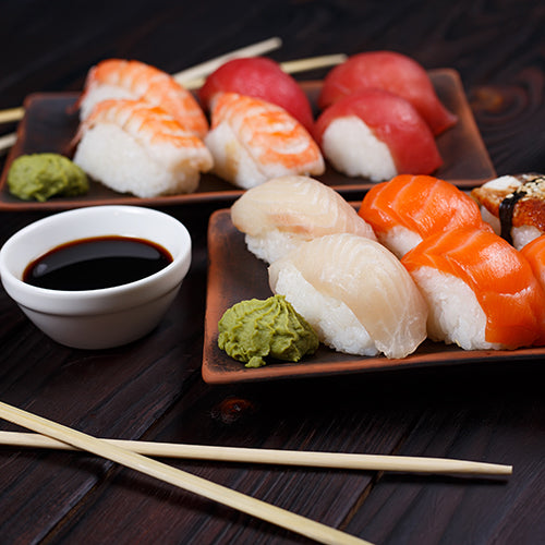 Set of Nigiri sushi served with soy sauce and chopsticks