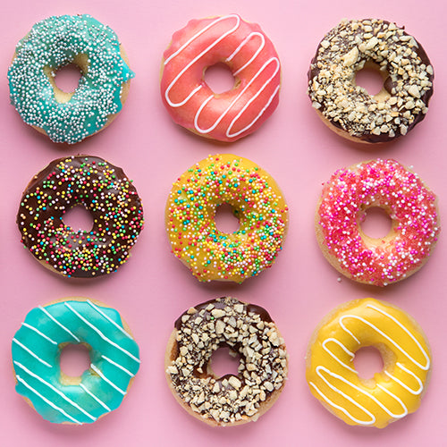 Variety of donuts on a pink background