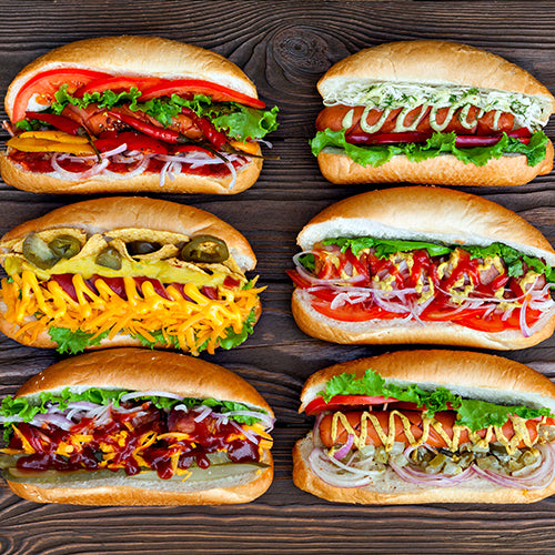 Various hot dogs on a wooden background