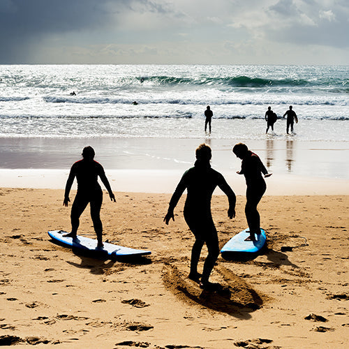 People learning to surf on the beach