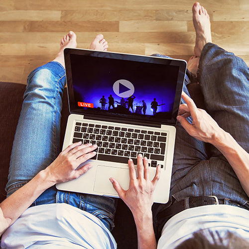 Couple live streaming online concert at home