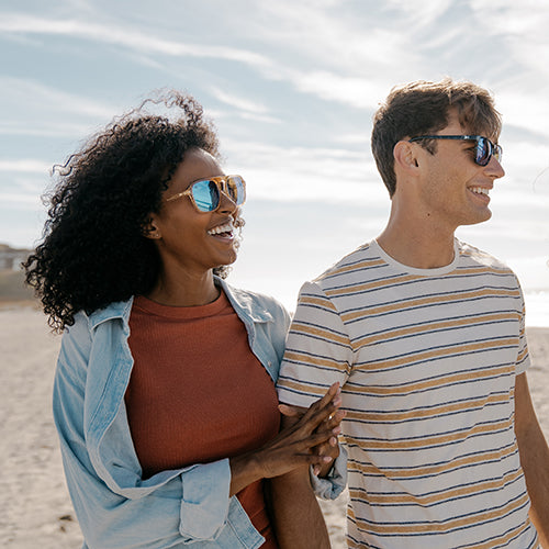 Guy and girl wearing Knockaround sunglasses at the beach
