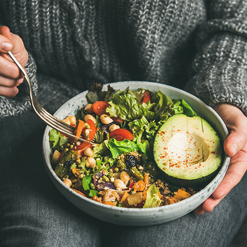 Woman eating a healthy salad bowl