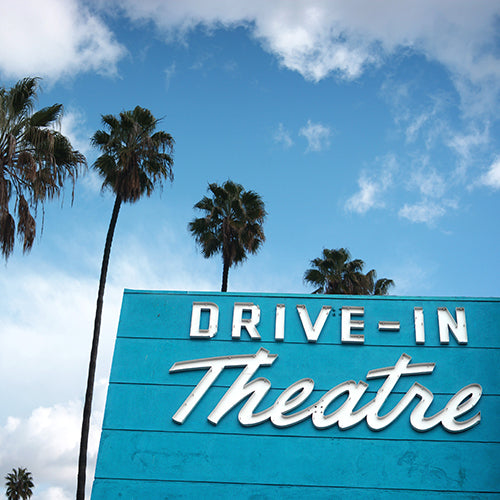 Drive-in theatre sign with palm trees
