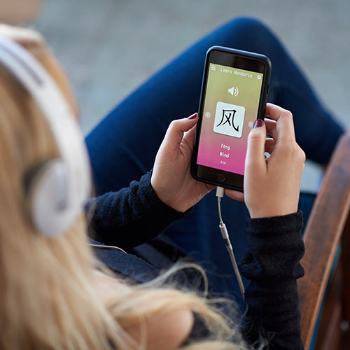 Woman using learning language app on smartphone
