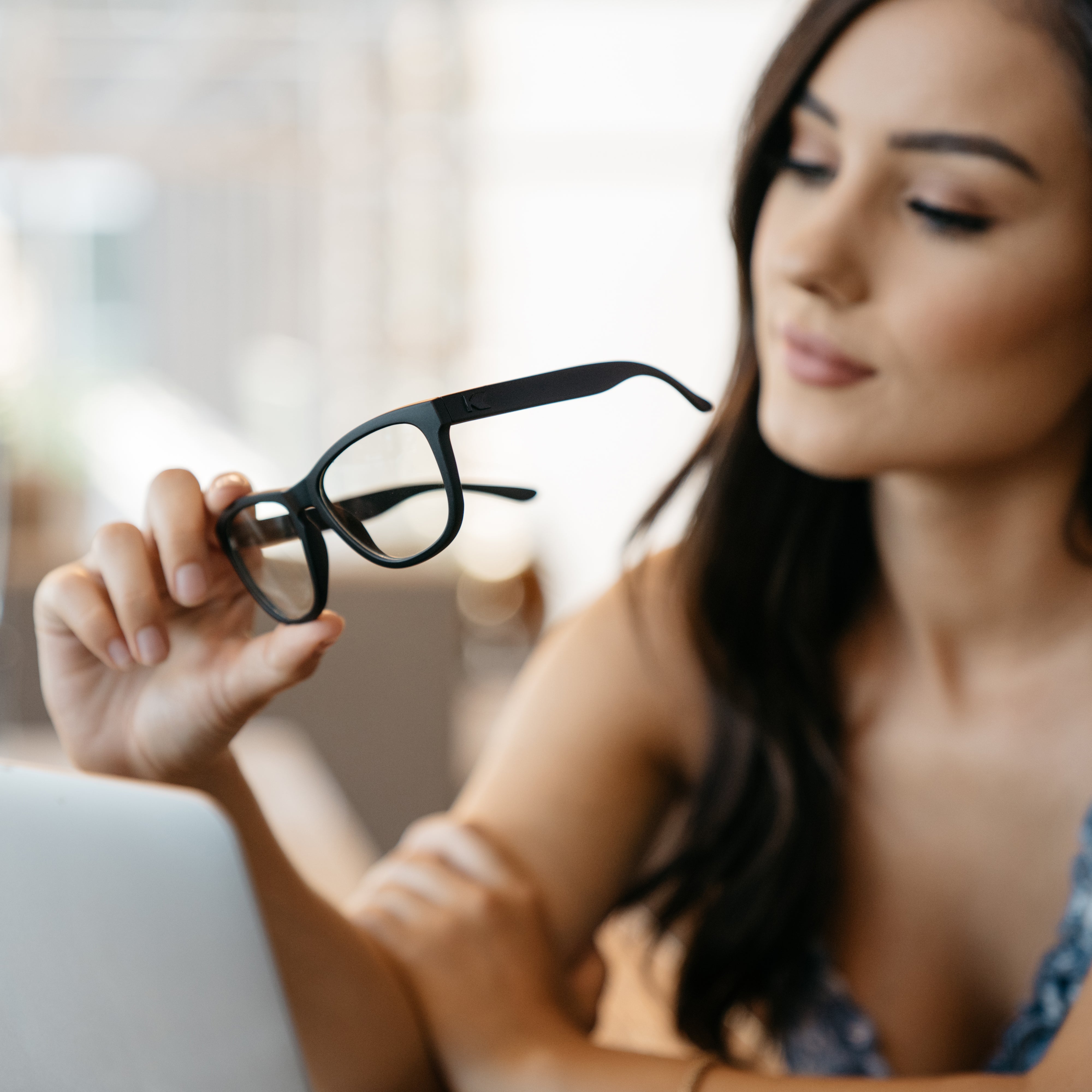 Model Holding Knockaround Blue Light Blockers 