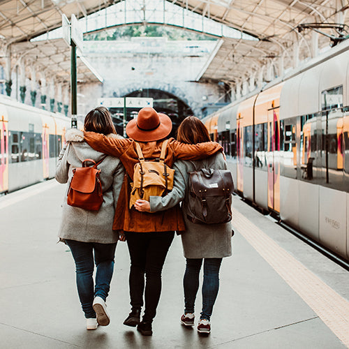 A group of young friends catching a train at the station