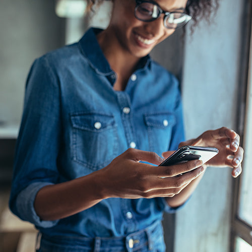 Woman using smart phone in the office