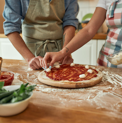 Couple making pizza together at home