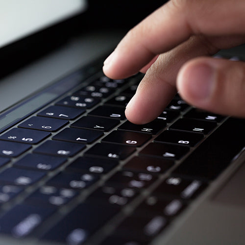 Finger typing on laptop