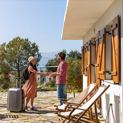 Host welcoming guest at house rental