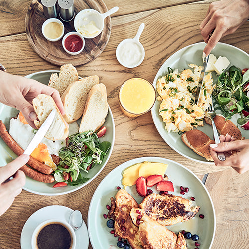 Two people having healthy breakfast in restaurant together