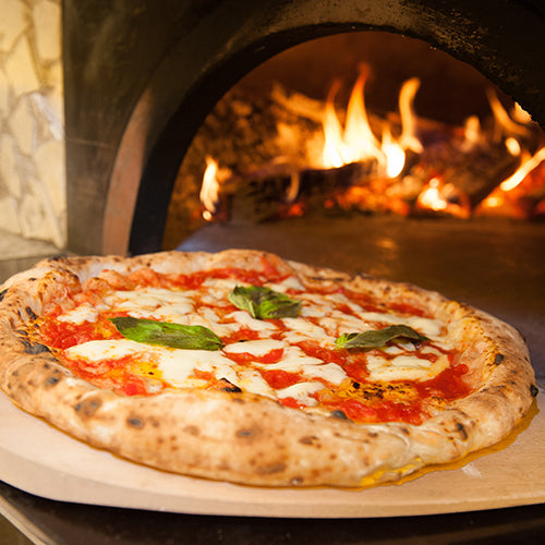 Margherita pizza fresh out of the wood-fired oven