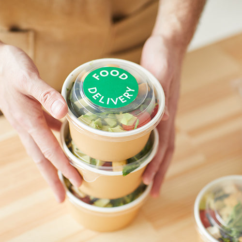 Waiter packaging food delivery orders