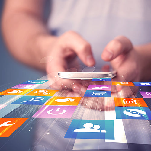 Hands holding smart phone with colorful application icons