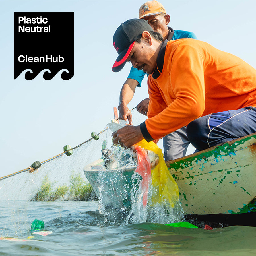 Two people picking up litter at the beach