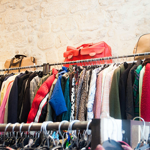 Various clothing items on a rack in a store