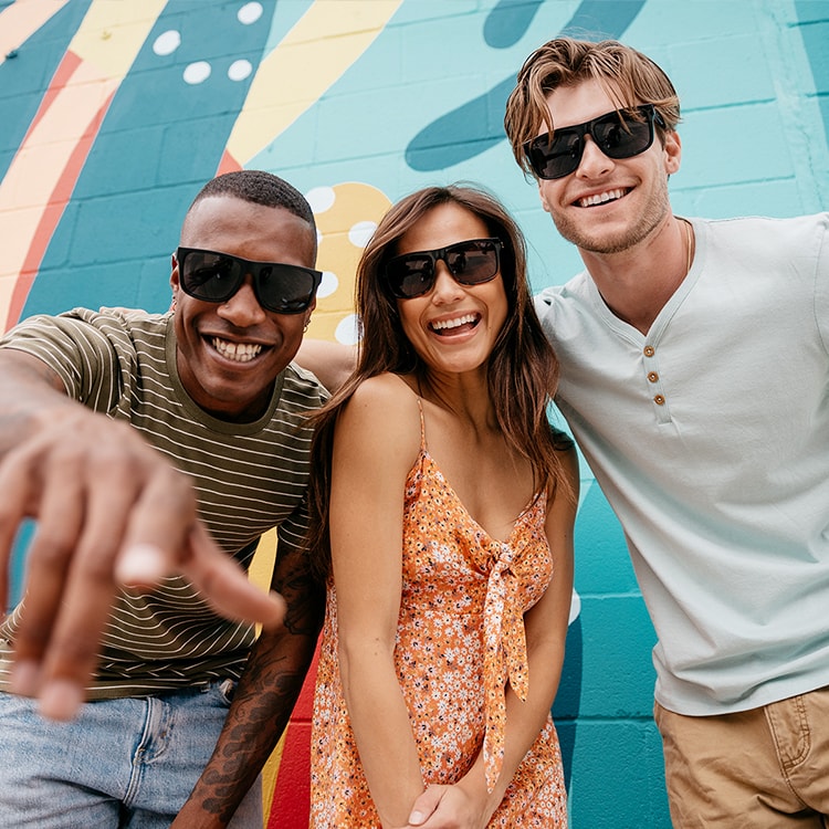 Two men and a woman wearing sunglasses
