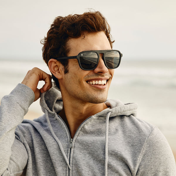 Man wearing Knockaround Black on Black Pacific Palisades Sunglasses